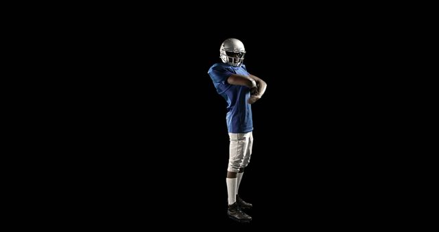 American Football Player Stretching Prepares for Game on Black Background - Download Free Stock Images Pikwizard.com