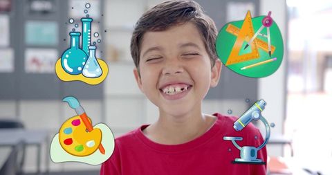 Joyful schoolboy smiling with missing tooth surrounded by colorful stem and art icons