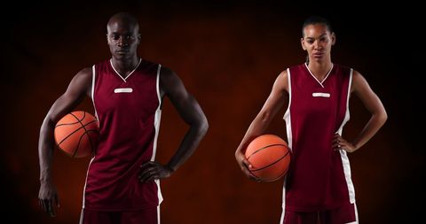 Confident Basketball Players Holding Basketballs on Black Background