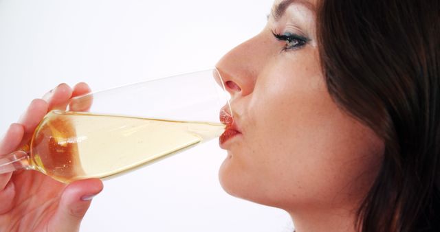 Woman Savoring White Wine with Relaxed Expression - Download Free Stock Images Pikwizard.com