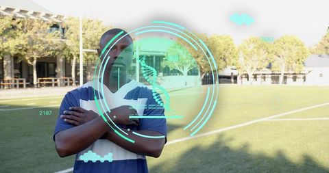 Confident male athlete on campus field with teal augmented reality dna hud overlay