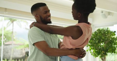 Joyful Couple Dancing Together at Home in Bright Room
