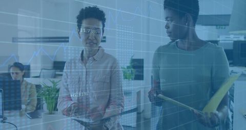 Business Women Analyzing Data with Digital Interface in Modern Office