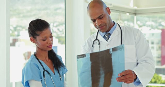 Experienced Doctor Explaining X-ray Results to Nurse in Medical Office - Download Free Stock Images Pikwizard.com