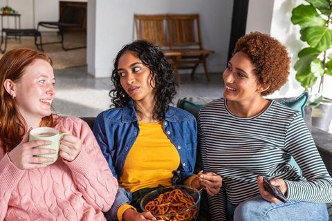 Diverse Friends Relaxing at Home with Snacks and Conversations