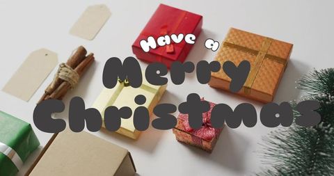 Minimal christmas gift flatlay with wrapped presents, tags, cinnamon and evergreen sprig