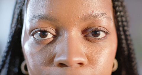 Closeup Portrait African American Woman Holding Steady Gaze Braided Hair Hoop Earrings