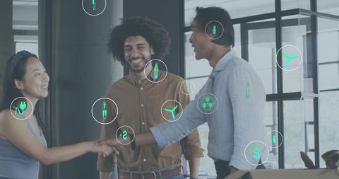 Business team shaking hands in open-plan office with energy and finance icons overlay