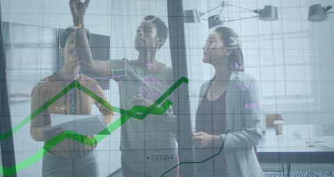 Diverse Business Team Analyzing Data on Glass Board