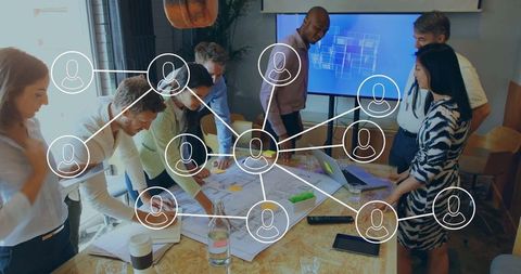 Creative team discussing architectural plans in office setting