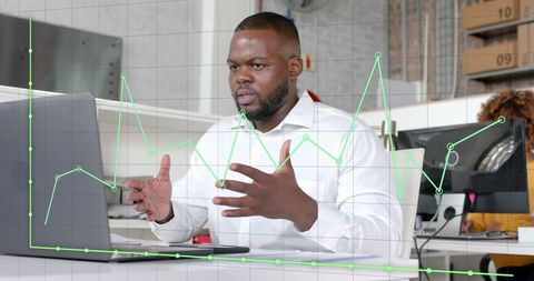 Businessman in Meeting Analyzing Financial Graphs on Laptop - Download Free Stock Images Pikwizard.com