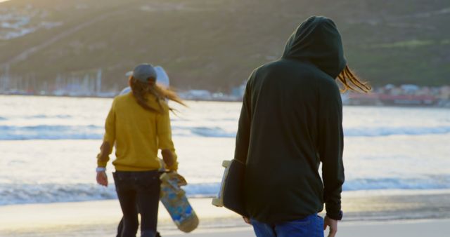 Teenagers Walking on Beach at Sunset with Skateboards - Download Free Stock Images Pikwizard.com