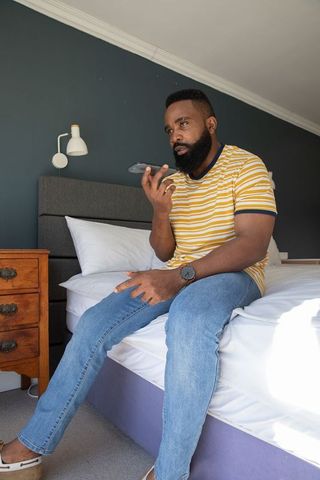 Man engaging in phone conversation while relaxing at home