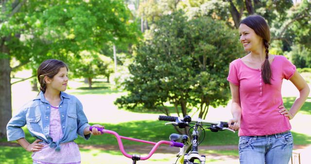 Mother and Daughter Spending Time Outdoors with Bicycle in Park - Download Free Stock Images Pikwizard.com