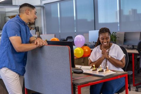 Coworkers Celebrating Office Birthday with Cupcakes and Balloons