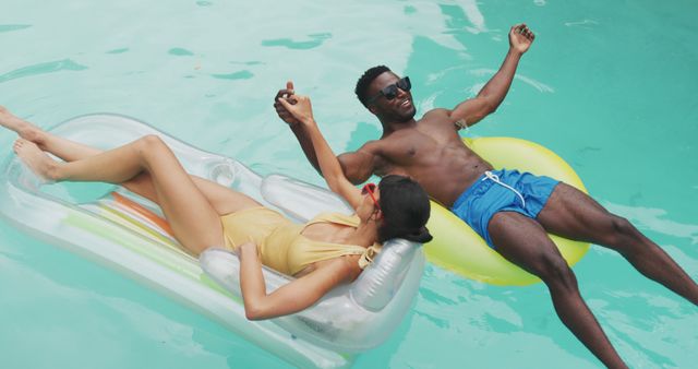 Joyful Couple Relaxing on Pool Inflatables Holding Hands - Download Free Stock Images Pikwizard.com