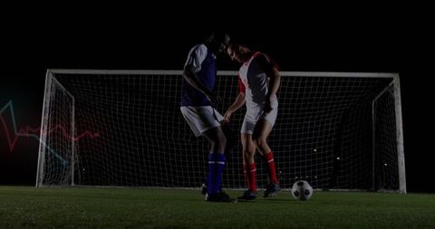 Intense Soccer Match at Night Under Spotlights