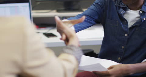 Diverse Coworkers Shaking Hands in Office Setting