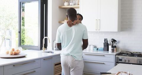 Couple Embracing in Modern Kitchen on Cozy Morning - Download Free Stock Images Pikwizard.com