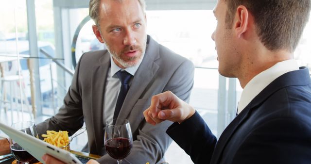 Two Businessmen Discussing at Restaurant Table - Download Free Stock Images Pikwizard.com