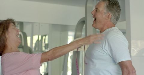 Senior couple measuring with tape measure for home renovation