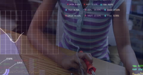 Child Working on Electronics with Financial Graph Overlay