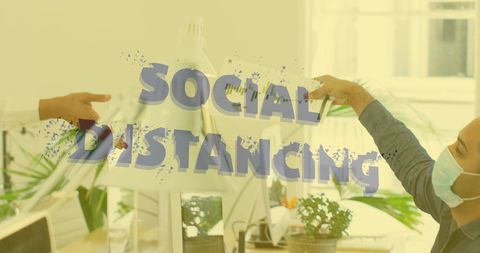 Colleagues maintaining social distance in office during pandemic