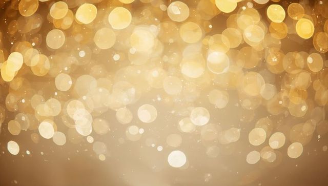 Shimmering Gold Bokeh Background with Glitter Specks for Festive Warm Ambient Designs
