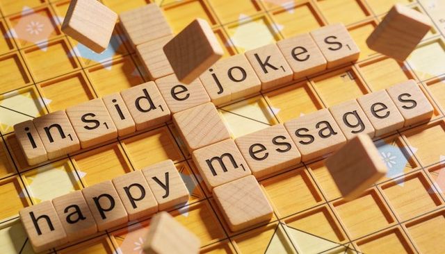 Sunlit wooden letter tiles forming happy messages and inside jokes on yellow board