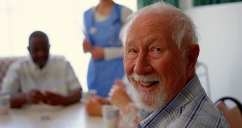 Joyful senior man socializing in nursing home community