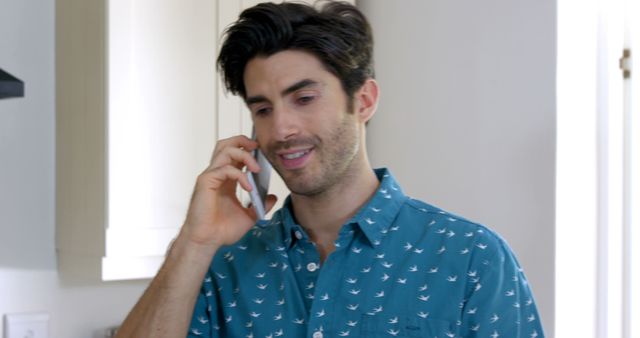 Smiling Man in Blue Shirt Talking on Smartphone Indoors - Download Free Stock Images Pikwizard.com