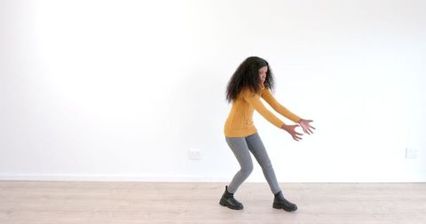 Woman Stretching in Bright Room Revealing Grace and Energy
