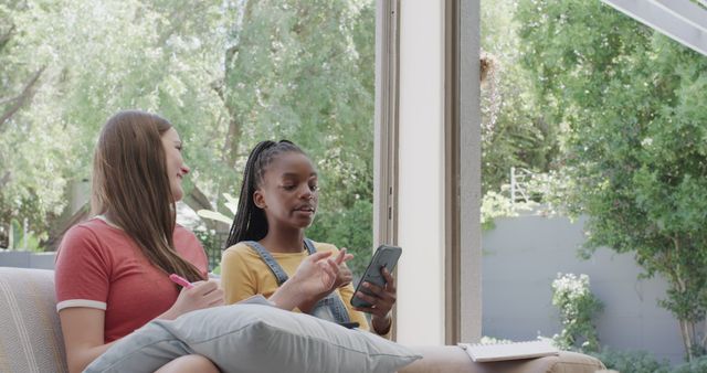 Teen Girls Laughing and Using Smartphone Inside Cozy Living Room - Download Free Stock Images Pikwizard.com