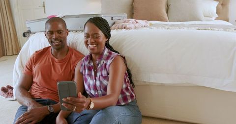 Happy Couple Touring Alternatives Via Smartphone Before Vacation