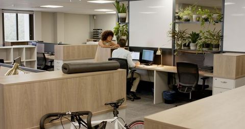 Diverse Team Collaborating in Modern Workspace with Greenery