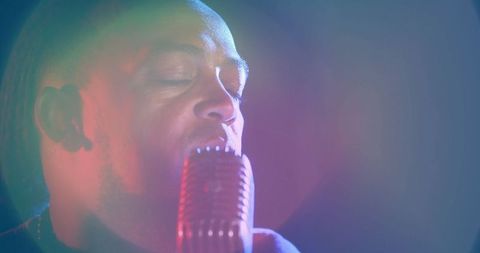 Passionate Male Singer Performing Under Colorful Stage Lights