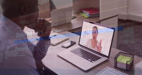 Watching remote video call on laptop with digital data overlay during office meeting