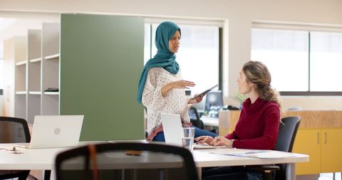 Diverse Creative Female Colleagues Collaborating in Office