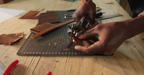 Artisan craftsmanship with precision tooling in leather workshop