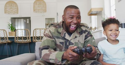 Father and Son Enjoying Video Games at Home