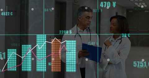 Medical Professionals Discussing Chart Data in Hospital Corridor