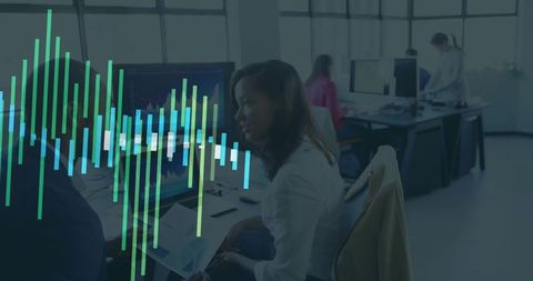 Business team analyzing data on office screens with charts