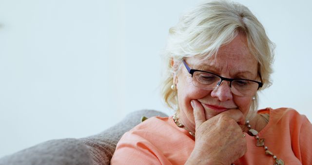 Thoughtful Senior Woman in Living Room Wearing Glasses - Download Free Stock Images Pikwizard.com
