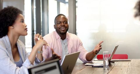 Diverse Coworkers Brainstorming Strategy in Office