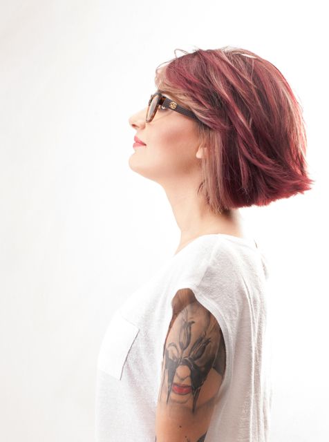 Profile of Woman with Red Hair and Tattoo Wearing Glasses - Download Free Stock Photos Pikwizard.com