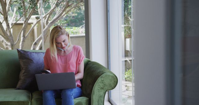 Young Woman Working from Home Using Laptop and Headset in Bright Living Room - Download Free Stock Images Pikwizard.com