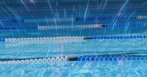 Sunlit pool surface with rippling blue water and lane dividers