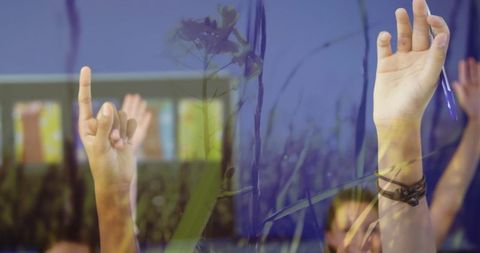 Students enthusiastically raising hands in classroom discussion