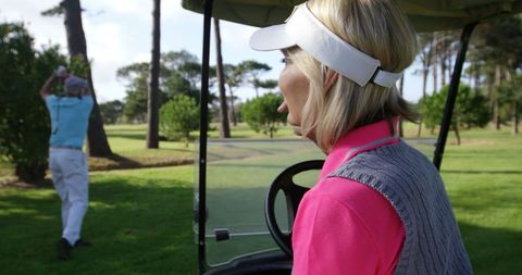 Joyful Woman Golfing Watching Teammate Swing