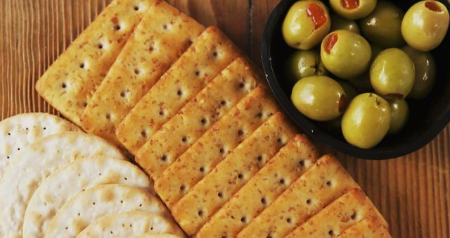 Crackers and Green Olives on Wooden Table - Download Free Stock Images Pikwizard.com